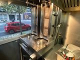 an image of a kitchen with a sink and a red car in the window