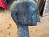 a small statue of a man sitting on a wooden table