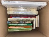 many books in a box that are stacked on top of each other