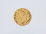 a gold coin with a woman ' s head on it