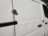 a white van that is parked on the side of the road