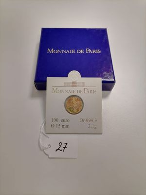 a close up of a box of coins on a table