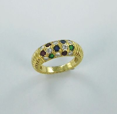 a close up of a gold ring with multi colored stones