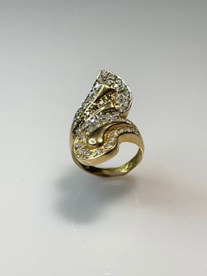 a close up of a gold ring with diamonds on a white surface