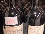 several bottles of wine are lined up on a shelf in a store