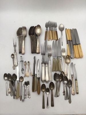 many different types of silverware on the table