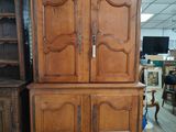 a large wooden cabinet in the middle of a room