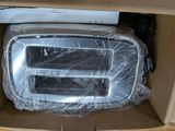 a box with a microwave inside of it that is wrapped in plastic