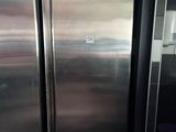two stainless steel refrigerators in a kitchen next to each other