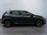 the grey car is parked in a large room with a white wall