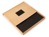 an open wooden box with a black square in it