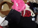 a pile of clothes that is sitting on the floor