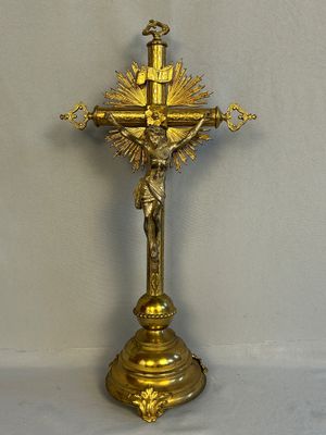 a gold cross with a crucifier on it
