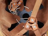 a close up of a helmet with leather straps on it