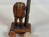 a wooden figurine with a bottle opener and a bottle opener
