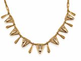 a gold plated necklace with a triangle shaped design on it