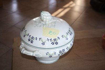 a white bowl with blue flowers on it sitting on a table