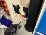 a pile of trash on the floor next to a blue door