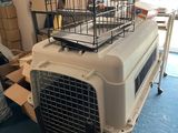 a dog crate with a cage on top of it