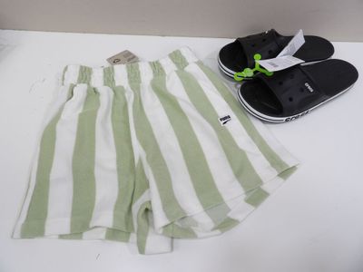 green and white striped shorts and flip flops on a white table