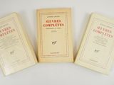 three books sitting on top of a white table next to each other