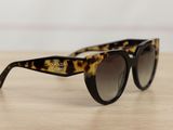 leopard print cat eye sunglasses on wooden table with white background