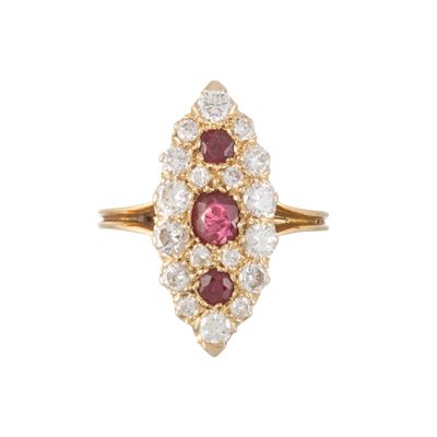 a close up of a diamond and ruby ring on a white background