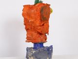 a sculpture made out of clay on a white surface