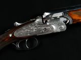 a close up of a gun on a black surface with a black background