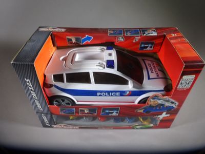 a toy police car in a box on a table