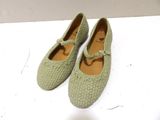 pair of women ' s shoes on a white surface with a white background