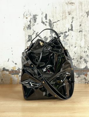 a black purse sitting on top of a wooden table