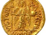 a close up of a gold coin with an image of a man on it