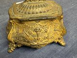 a gold colored box sitting on top of a blue couch
