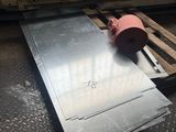 a piece of metal sitting on a pallet in a warehouse