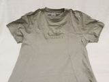 an old photo of a t - shirt sitting on top of a sheet