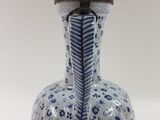 a blue and white vase on a white table