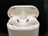 a pair of airpods sitting in a case on a black surface