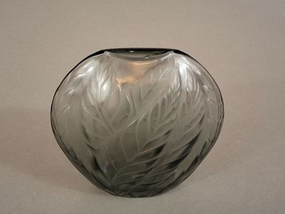 a black and white vase sitting on a white surface