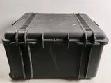 a black plastic case sitting on top of a white floor