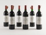 six bottles of red wine lined up in a row