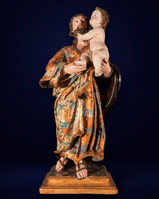 une statue d'un homme tenant un bébé dans ses bras