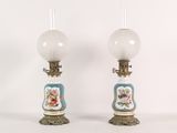 pair of antique porcelain lamps with painted vases on bases