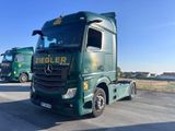 deux camions verts garés l'un à côté de l'autre sur un parking