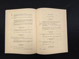 an open book on a black table with a black background