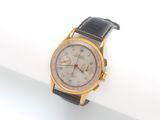 l'image d'une montre en or et noir sur une surface blanche