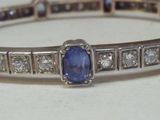 une photo d'un bracelet en saphir bleu et diamants posé sur une table