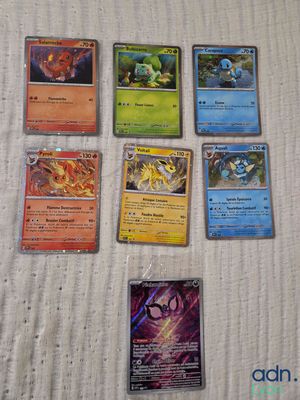 a lot of different pokemon cards on the table