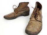 an old pair of brown leather shoes with laces on them