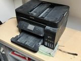a printer sitting on top of a desk next to a printer